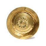 A GERMAN BRASS ALMS DISH NUREMBERG, 17TH CENTURY the centre with a repousse whorl, within a Gothic