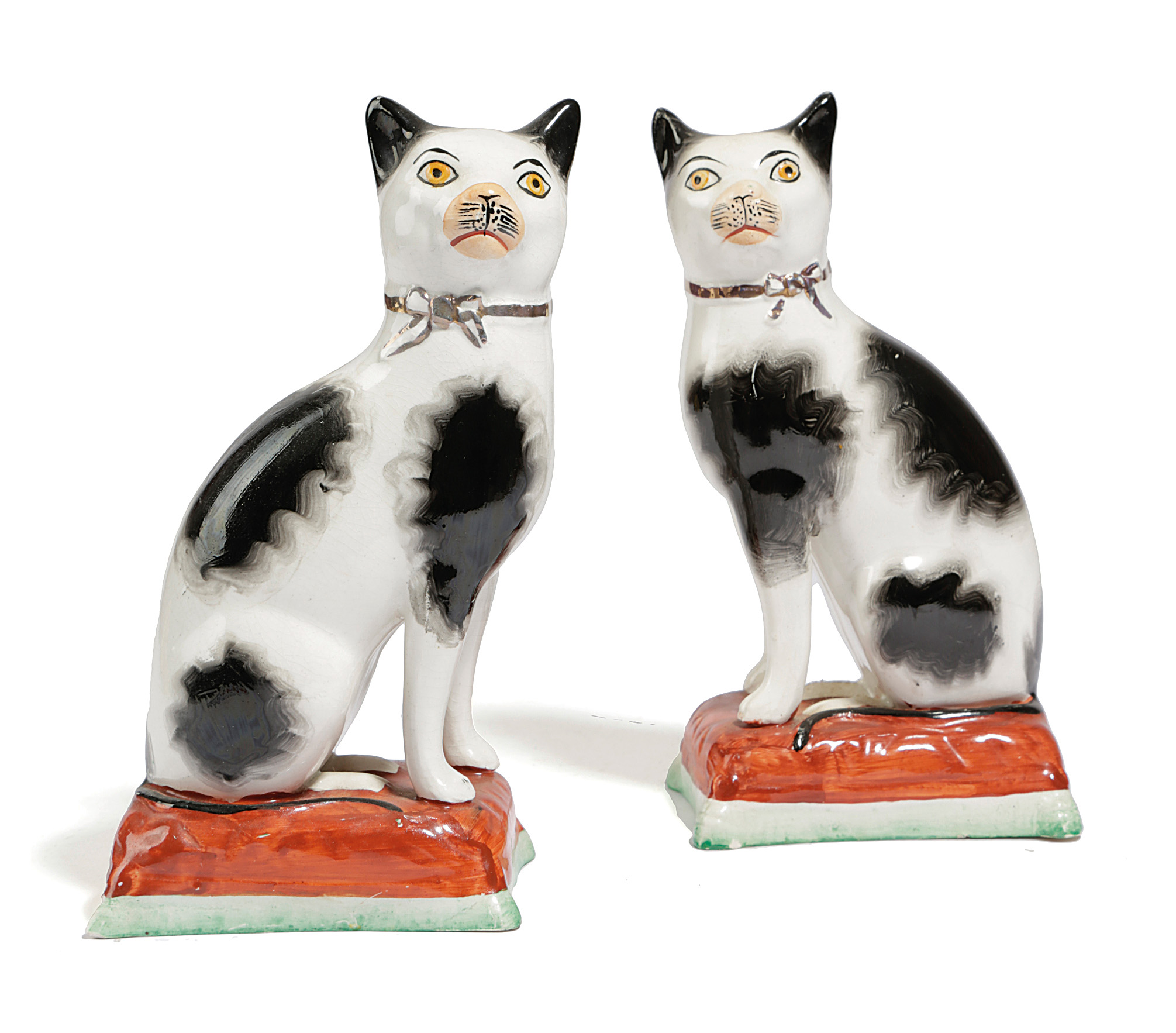 A PAIR OF STAFFORDSHIRE POTTERY MODELS OF CATS C.1860 each painted with black spots and a gilt