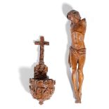 A CONTINENTAL CARVED WOOD CORPUS CHRISTI FIGURE 17TH CENTURY together with a treen coquilla nut holy