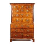 A GEORGE II WALNUT CHEST ON CHEST C.1730 with three short and six long cross and feather banded