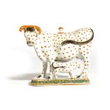 A YORKSHIRE PRATT WARE POTTERY COW CREAMER C.1800 the large bovine accompanied by her calf, both