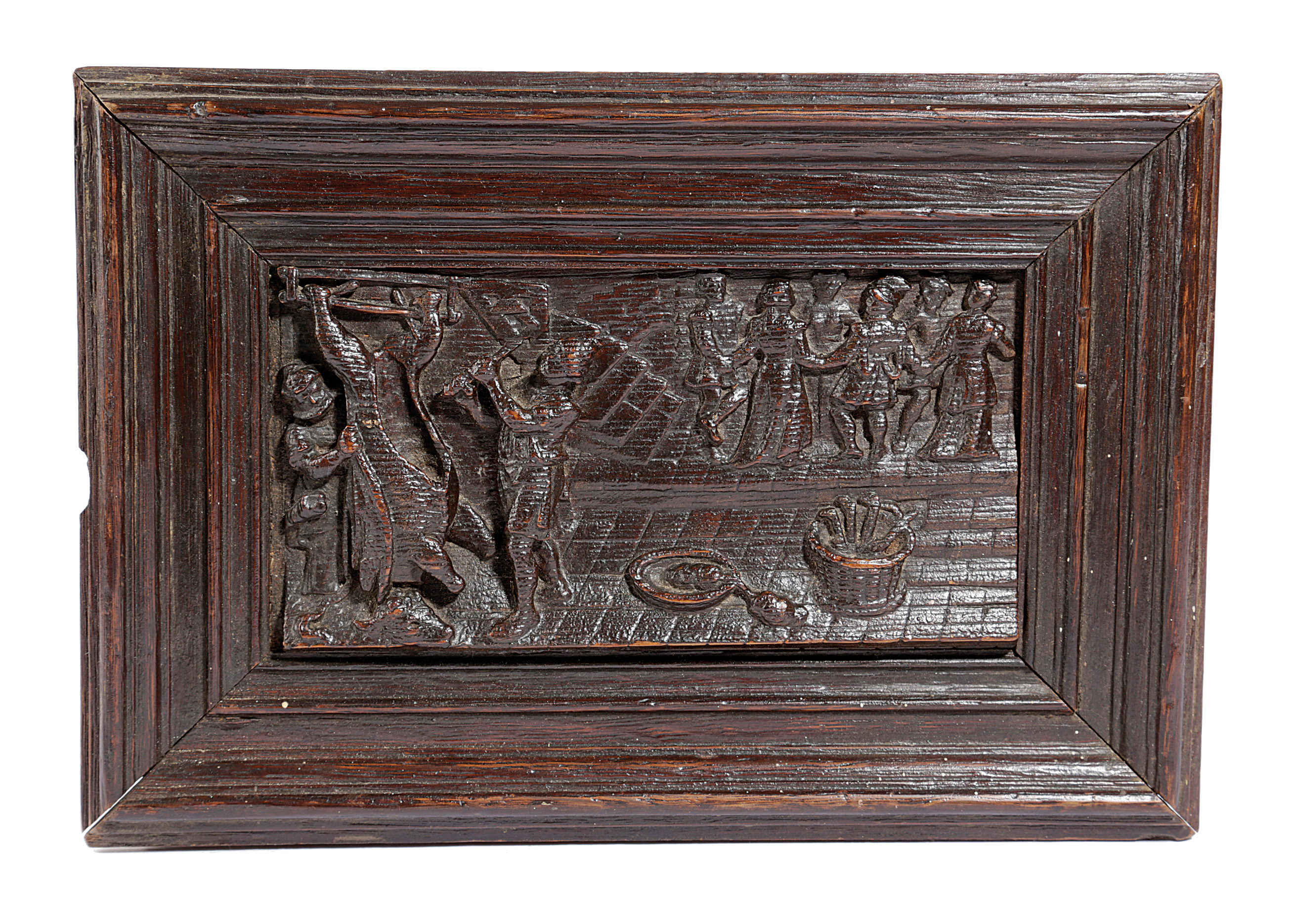A DUTCH OAK PANEL 17TH CENTURY relief carved with two men butchering a cow, with a basket of