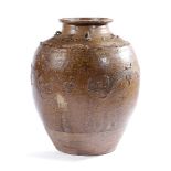 A SOUTH EAST ASIAN POTTERY STORAGE JAR PROBABLY 17TH / 18TH CENTURY with a flared neck applied