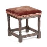 A CHARLES II OAK UPHOLSTERED STOOL C.1660 the seat with later velvet upholstery, above a moulded