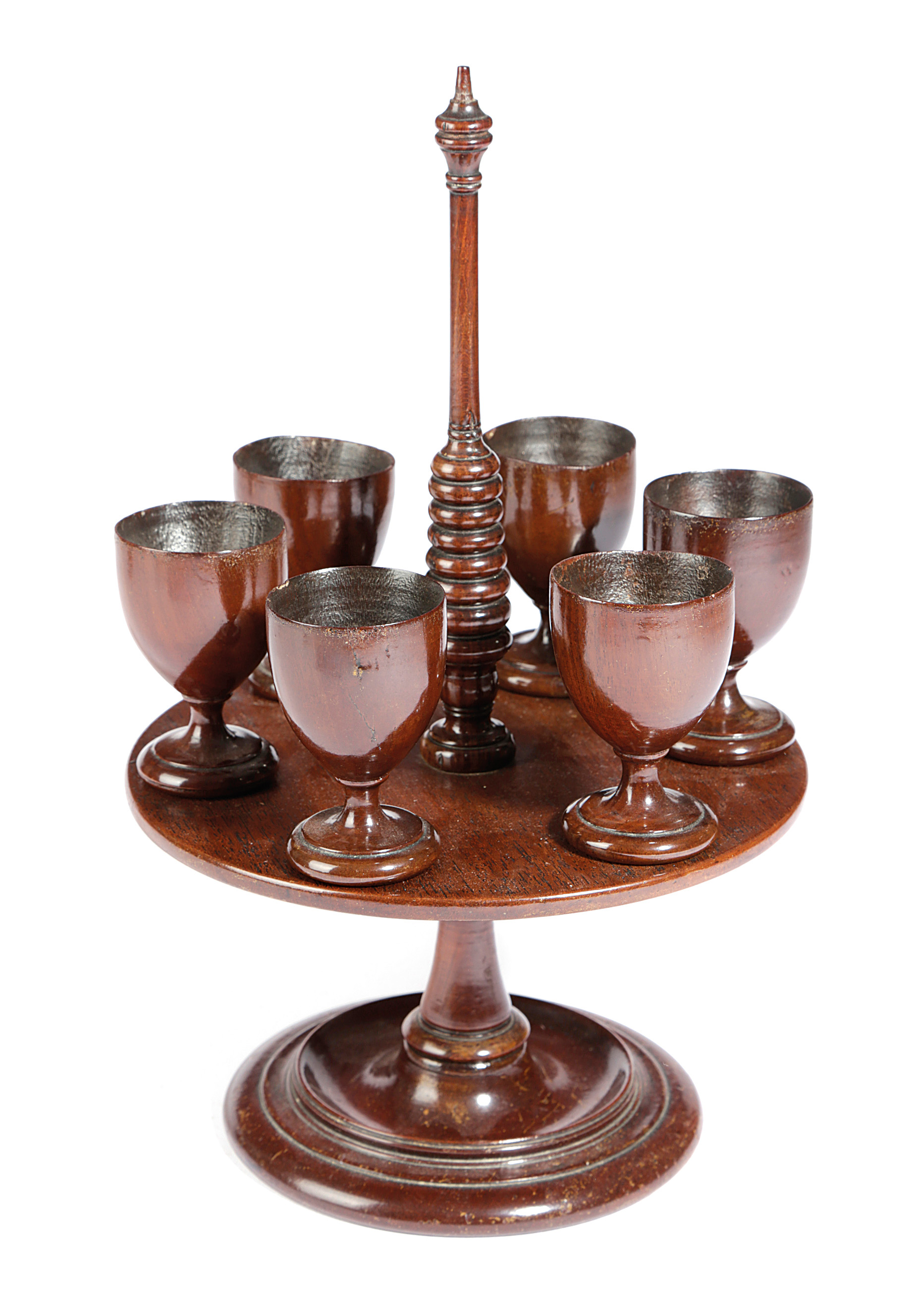 AN EARLY VICTORIAN TREEN MAHOGANY EGG CRUET C.1840 with a ring turned stem above revolving tray with