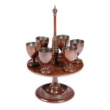 AN EARLY VICTORIAN TREEN MAHOGANY EGG CRUET C.1840 with a ring turned stem above revolving tray with