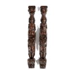 A PAIR OF OAK FIGURAL TERMS LATE 16TH / EARLY 17TH CENTURY each with a capital above a basket of