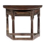 AN OAK CREDENCE TABLE 17TH CENTURY with a demi-lune top above a canted base, with a frieze drawer,