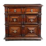 A CHARLES II OAK CHEST C.1680 of three long drawers, with panelled fronts and applied with turned