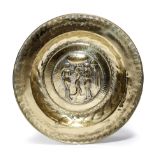 A GERMAN BRASS ALMS DISH NUREMBERG, 17TH CENTURY the centre decorated with Adam and Eve within a