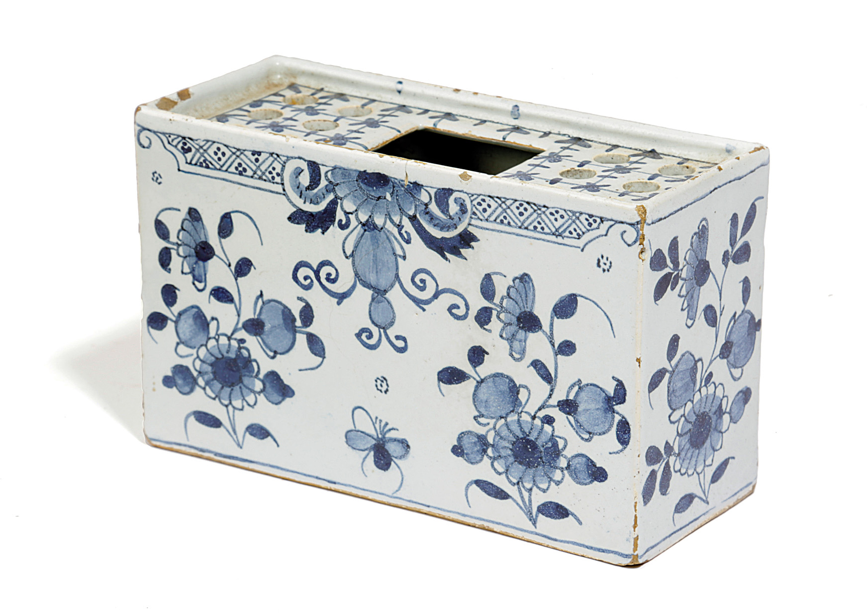 A DELFTWARE POTTERY BLUE AND WHITE FLOWER BRICK C.1740-60 painted with flowers in Chinese style, the