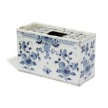 A DELFTWARE POTTERY BLUE AND WHITE FLOWER BRICK C.1740-60 painted with flowers in Chinese style, the
