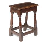 A CHARLES II OAK JOINT STOOL C.1660-70 the seat with a moulded edge, on ring turned and incised