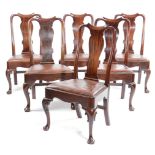 A SET OF SIX GEORGE II RED WALNUT DINING CHAIRS C.1740 each with a scroll carved and curved top rail