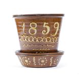AN EARLY VICTORIAN STAFFORDSHIRE SLIPWARE POTTERY PLANT POT DATED '1859' with a brown glaze and