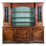 AN OAK BREAKFRONT DRESSER NORTH COUNTRY, EARLY 19TH CENTURY the raised plate rack with an arched