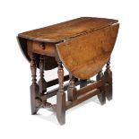 A WILLIAM AND MARY OAK GATELEG TABLE C.1690 the oval drop-leaf top above an end frieze drawer on
