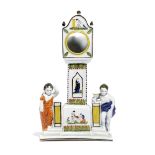 A PRATT WARE POTTERY WATCH STAND NORTH COUNTRY, C.1800 modelled as a longcase clock flanked by a boy