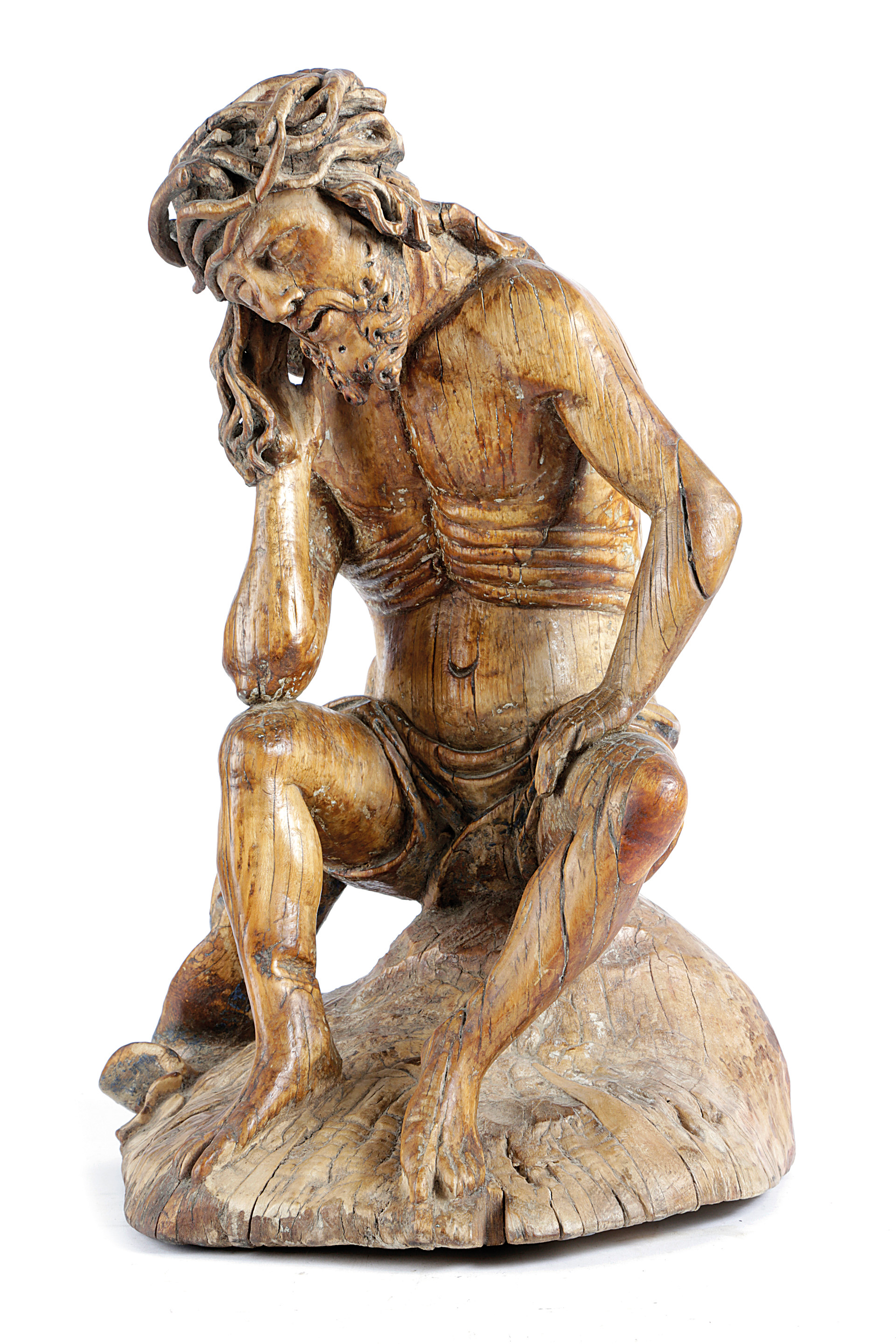 A GERMAN CARVED LIMEWOOD FIGURE OF CHRIST THE MAN OF SORROWS 16TH CENTURY depicted seated wearing