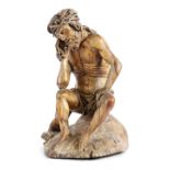 A GERMAN CARVED LIMEWOOD FIGURE OF CHRIST THE MAN OF SORROWS 16TH CENTURY depicted seated wearing