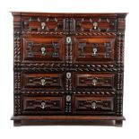 A CHARLES II OAK AND CEDAR CHEST C.1680 in two halves, with four long geometric panelled doors, with