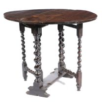 A SMALL CHARLES II OAK GATELEG TABLE C.1680 the oval drop-leaf top on turned spiral twist ends and