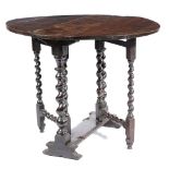 A SMALL CHARLES II OAK GATELEG TABLE C.1680 the oval drop-leaf top on turned spiral twist ends and