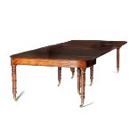 A GEORGE IV MAHOGANY EXTENDING DINING TABLE C.1830 the top with a moulded edge, with a hinged