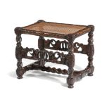 A CHARLES II OAK STOOL C.1670-80 with a later cushion above a caned seat, on spiral twist and flower