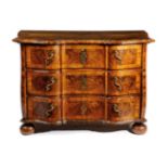 A GERMAN WALNUT SERPENTINE COMMODE 18TH CENTURY the quarter veneered and crossbanded top with a