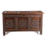 A CHARLES II OAK COFFER C.1670 the triple panelled top with later hinges revealing a vacant