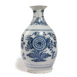 A DELFT POTTERY BLUE AND WHITE VASE EARLY 18TH CENTURY of pear shape, with an everted rim, painted