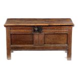 A SMALL OAK COFFER LATE 17TH CENTURY the hinged top revealing a vacant interior with a twin panelled
