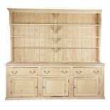 A LARGE PINE DRESSER 19TH CENTURY AND LATER the later plate rack with three shelves, the base with