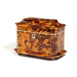 λ A REGENCY TORTOISESHELL TEA CADDY EARLY 19TH CENTURY of sarcophagus shape and inlaid with pewter