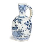 A DELFT POTTERY BLUE AND WHITE JUG OR EWER C.1680-1700 painted in Chinese style with a bird,