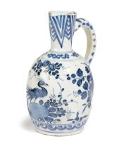 A DELFT POTTERY BLUE AND WHITE JUG OR EWER C.1680-1700 painted in Chinese style with a bird,