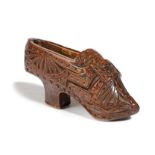 A TREEN SNUFF SHOE 19TH CENTURY with chip carved decoration 10cm long Provenance Upper Slaughter