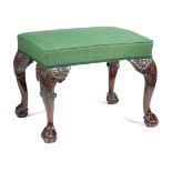 A GEORGE II IRISH WALNUT STOOL C.1740 the padded seat covered with green fabric, on cabriole legs