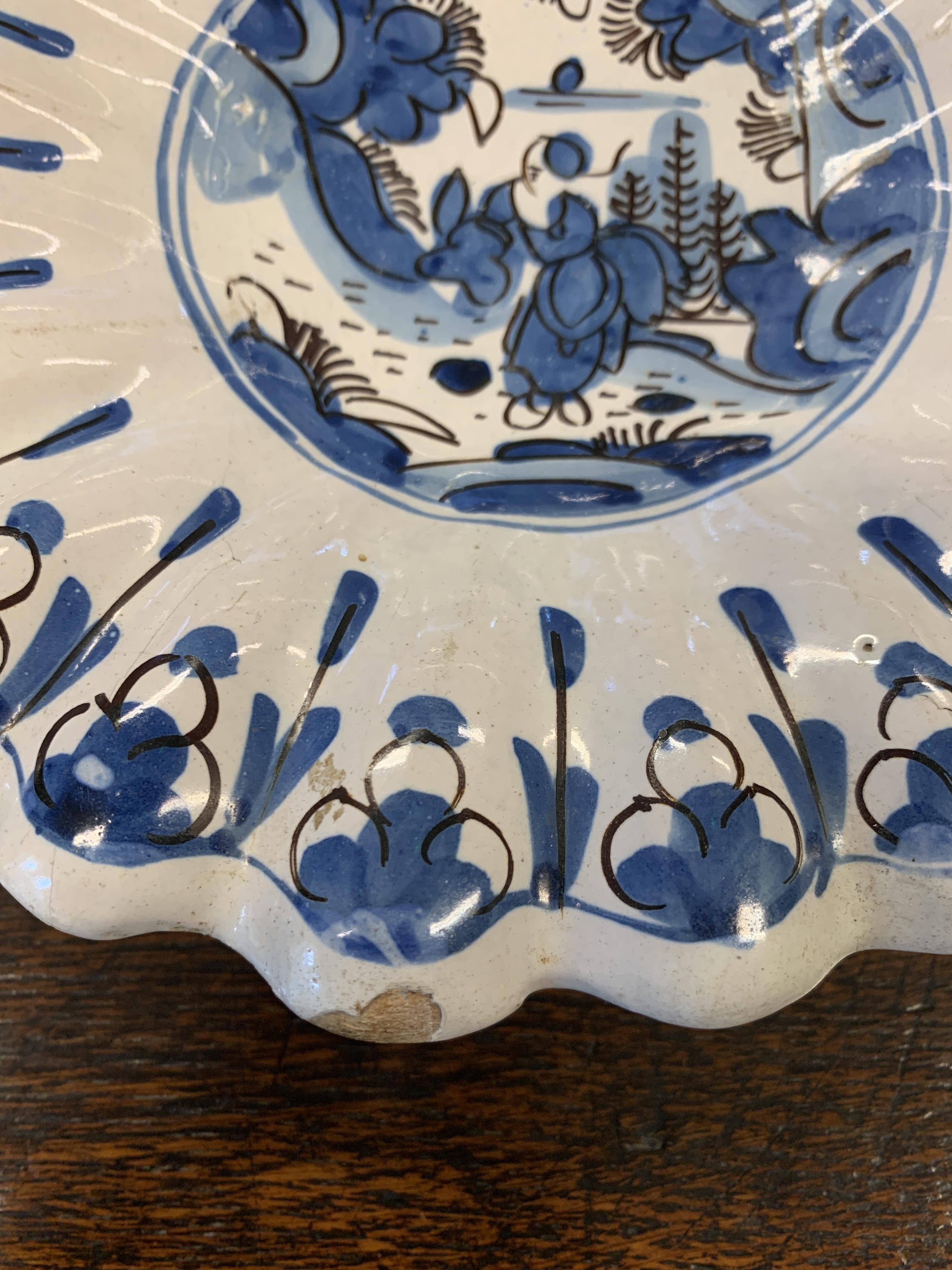 TWO DELFT POTTERY LOBED DISHES EARLY 18TH CENTURY each painted in blue and black with a seated - Image 9 of 16