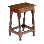A CHARLES II OAK JOINT STOOL C.1660 with an elm seat above a moulded frieze, on ring turned baluster