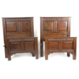 TWO SIMILAR SINGLE OAK BEDS 17TH CENTURY ELEMENTS each with a panelled head and footboard, one