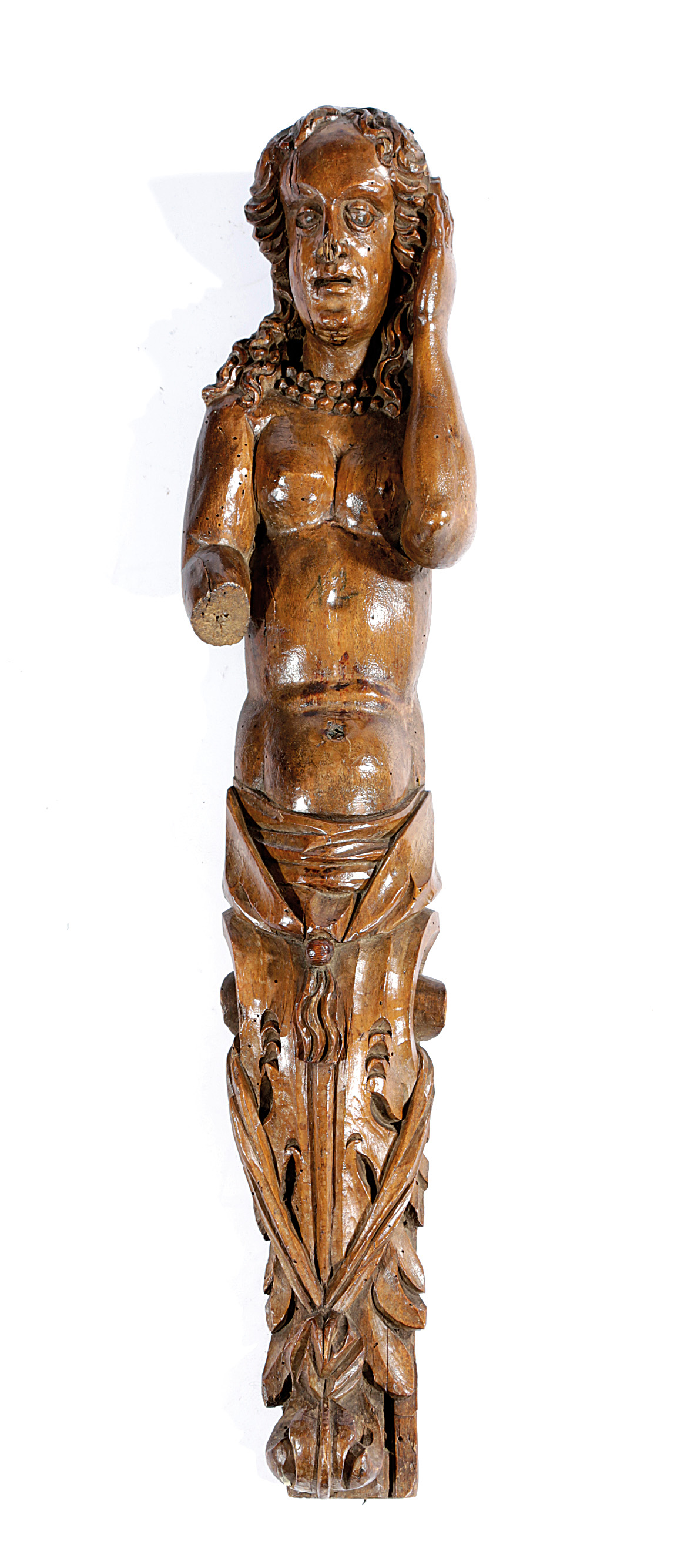 A WALNUT FIGURAL TERM POSSIBLY FLEMISH OR FRENCH, LATE 16TH CENTURY carved with a semi-naked