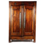 A FRENCH PROVINICAL CHESTNUT AND OAK ARMOIRE LATE 18TH / EARLY 19TH CENTURY the frieze carved with