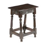 A CHARLES II OAK JOINT STOOL C.1660 the rails carved with leaf motifs, on bobbin and baluster turned