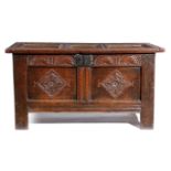 A CHARLES II OAK COFFER C.1680 the hinged triple panelled top revealing a vacant interior originally