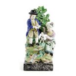 A STAFFORDSHIRE PEARLWARE POTTERY GROUP EARLY 19TH CENTURY depicting rural pastimes, with a man