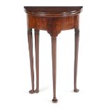 A DIMINUTIVE GEORGE II RED WALNUT DEMI-LUNE TEA TABLE C.1730-40 the twin hinged fold-over top on a