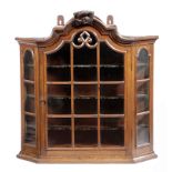 A DUTCH OAK HANGING DISPLAY CABINET 19TH CENTURY with an arched astragal glazed door enclosing three