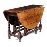 AN OAK GATELEG TABLE LATE 17TH / EARLY 18TH CENTURY the oval drop-leaf top on baluster and bobin